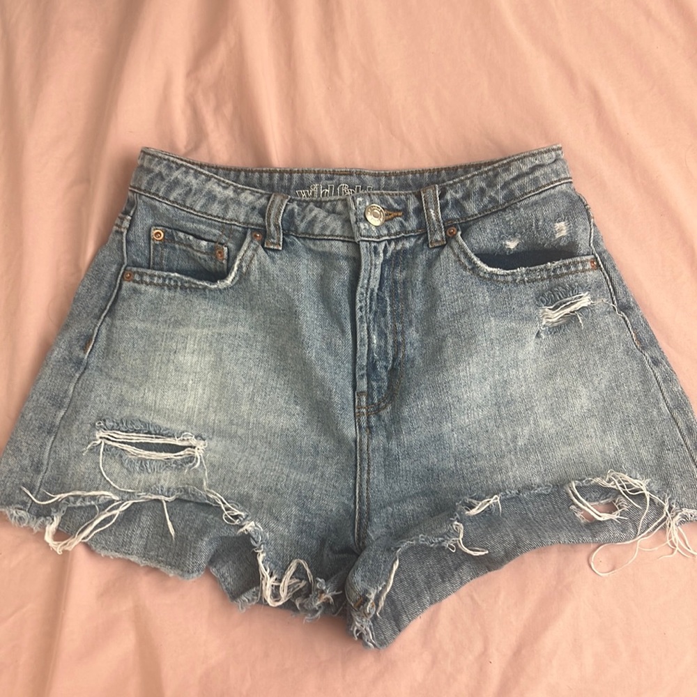 ripped blue jean shorts.